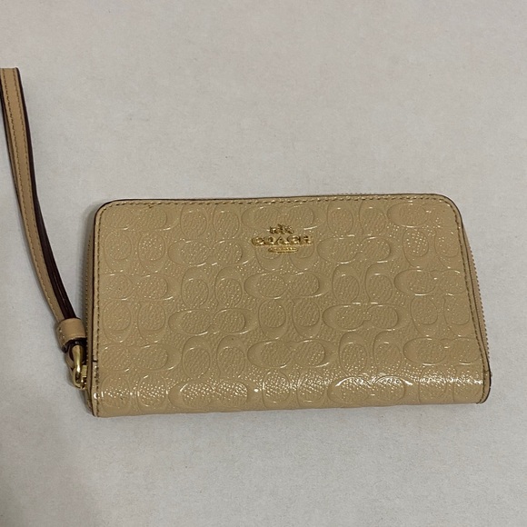 Coach Handbags - Coach Beige Embossed Wristlet